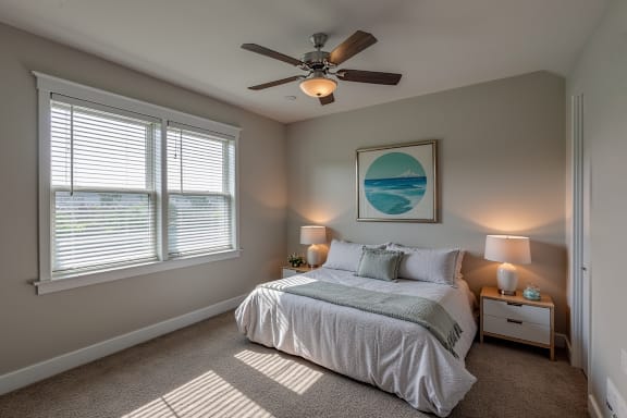 A bedroom with a bed, two lamps, and a painting on the wall at Mode at Melbourne, LLC Apartments, Florida, 32901
