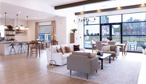 A modern living room with a bar area and a view of the outdoors.