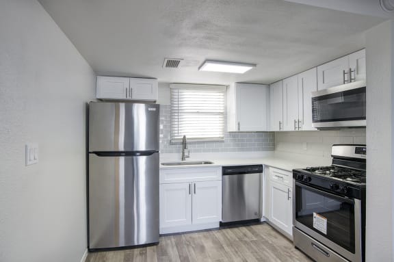 kitchen with stainless steel appliances and white cabinets at Mark at 87 Apartments, Mesa