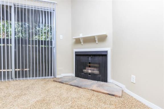 a living room with a fireplace and a window