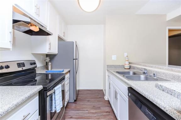 a kitchen with a stove a sink and a refrigerator