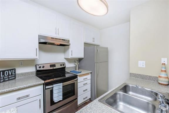 a kitchen with a stove a sink and a refrigerator