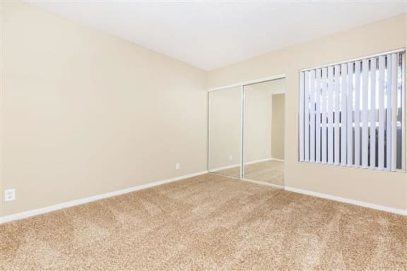 a room with a window and a mirror