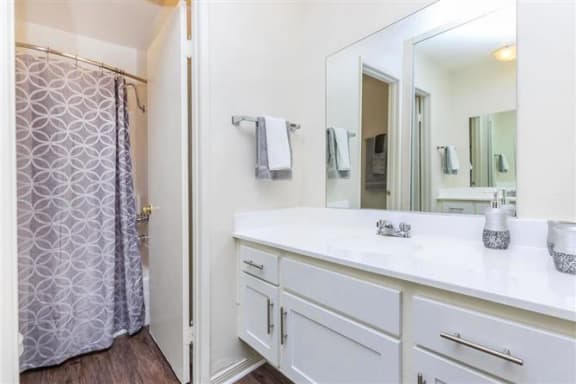 a bathroom with a large mirror and a shower