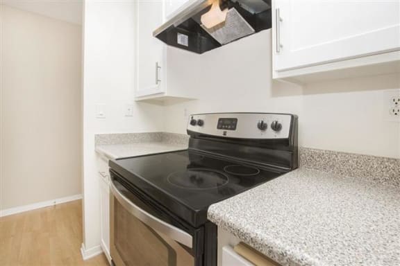 a kitchen with a stove top oven next to a counter