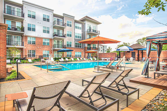 Outdoor pool deck with lounge chairs and cabanas at Inwood at Renaissance Square Apartments, New Jersey, 08053