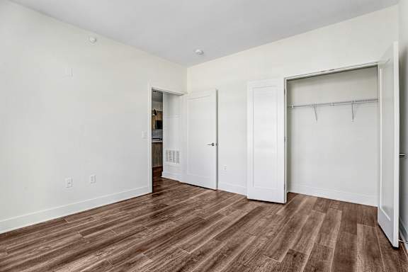 Empty bedroom with closet and wood flooring at Inwood at Renaissance Square Apartments, Marlton