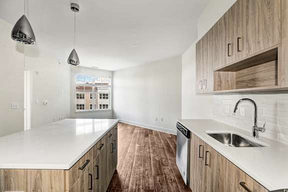 Modern kitchen with island and quartz countertops at Inwood at Renaissance Square Apartments, Marlton, NJ 08053