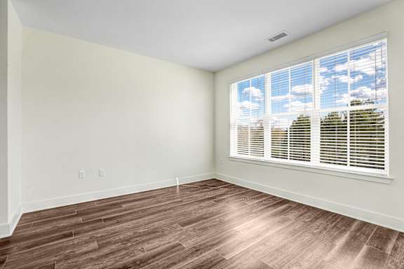 Empty bedroom with large windows and wood flooring at Inwood at Renaissance Square Apartments, New Jersey