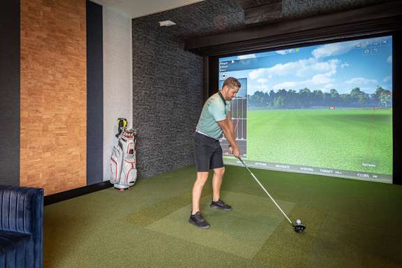 Indoor golf simulator with projection screen at Inwood at Renaissance Square Apartments, Marlton, 08053