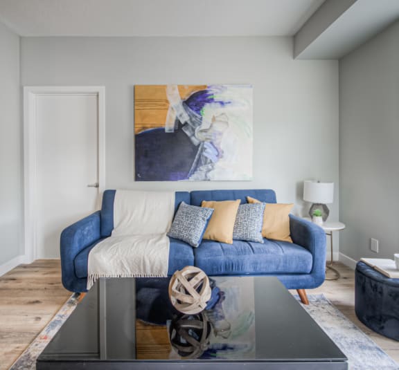 a living room with a blue couch and a coffee table