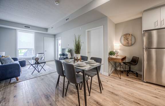 A modern dining room with a wooden table and chairs.