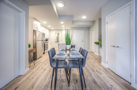 a dining room with a table and chairs and a kitchen