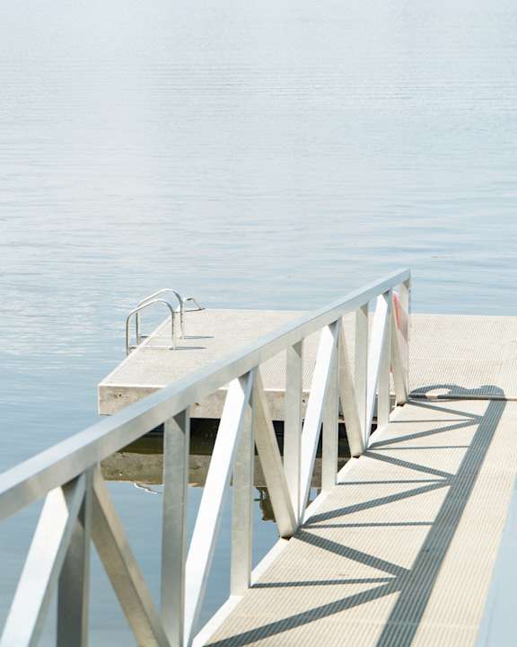 a dock on the water with a bench
