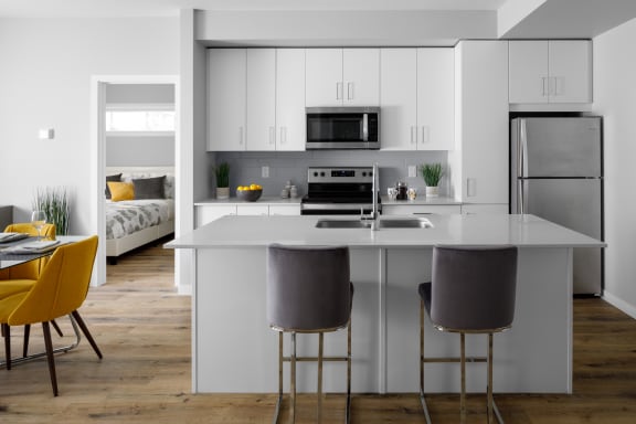 a kitchen with white cabinets and a white counter top