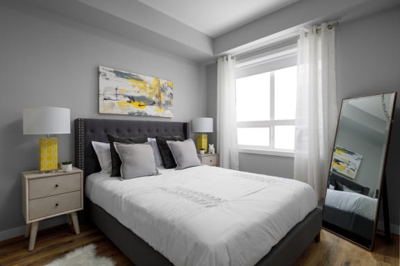 a bedroom with a large bed and a large window