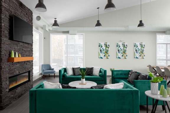 a living room with green couches and a fireplace