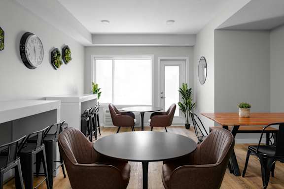 A modern dining room with a round table and chairs.