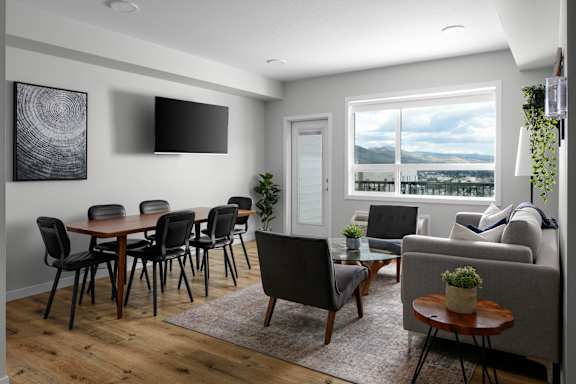 A modern living room with a dining table and chairs.