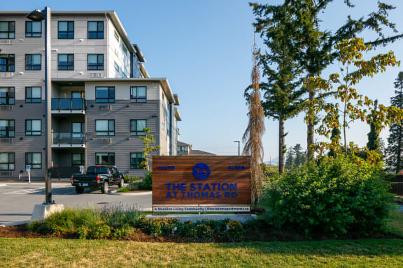 an apartment building with a sign that reads the station on hooks