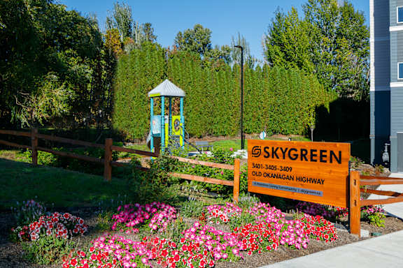 A sign for Skygreen with a phone number and address on it.