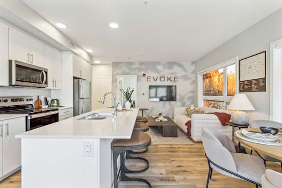 A modern kitchen with white cabinets and a white island.
