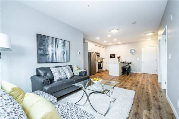 A living room with a grey couch and a coffee table.