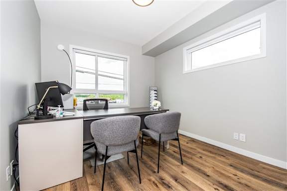 A room with a desk, chair, and a window.