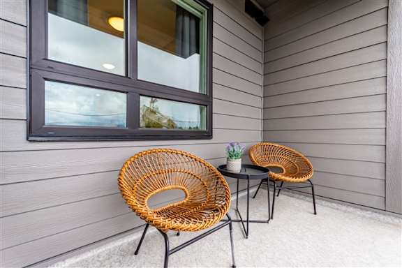 Two wicker chairs are placed on a patio table.