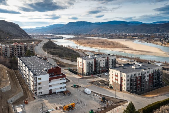 an aerial view of a city with a river and buildings