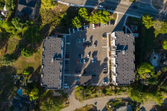 a birds eye view of a building with cars parked on the street