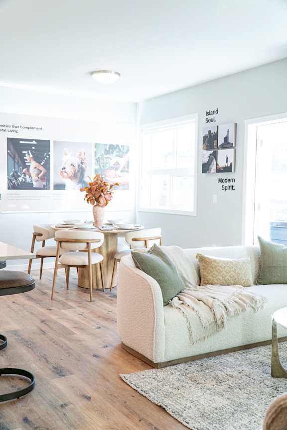 A modern living room with a white couch and a coffee table.