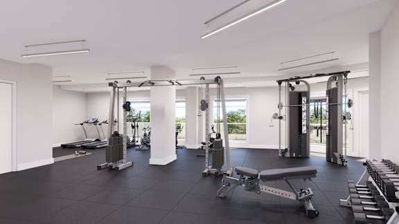 A spacious gym with a variety of equipment including treadmills, weights, and benches.