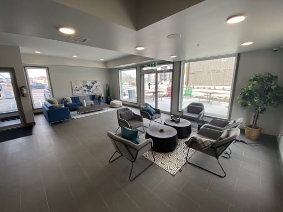 a communal area with couches and chairs and tables in a lobby of a building
