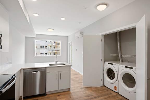 A laundry room with a washer and dryer in it.