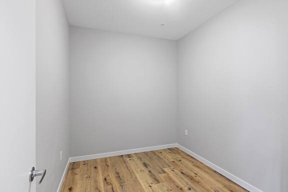 A room with a wooden floor and white walls.