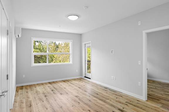 A room with a window and a door.