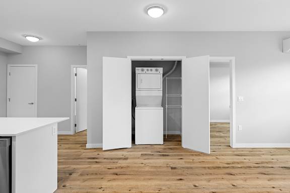 A white kitchen with a refrigerator and a dishwasher.