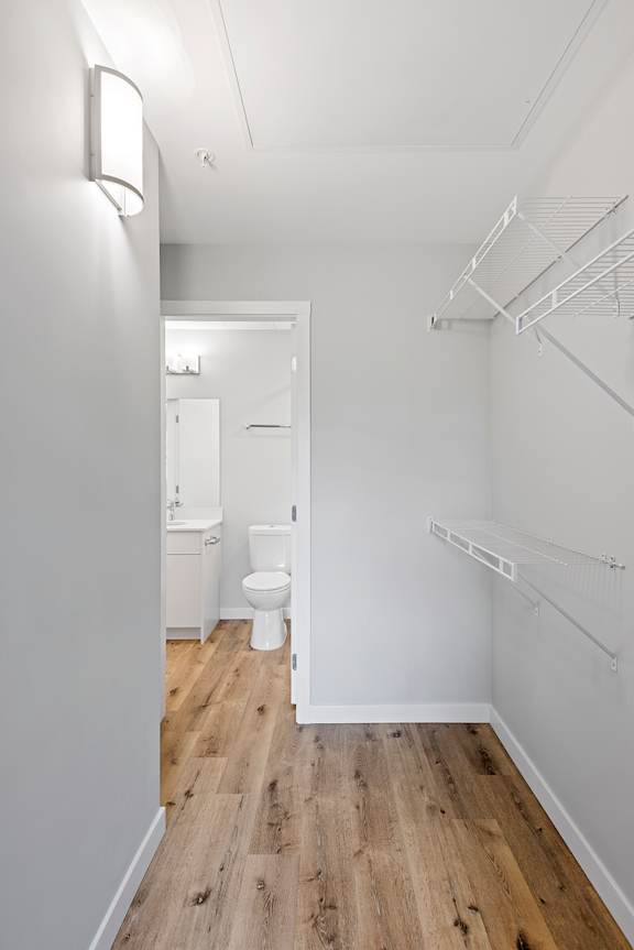 A white bathroom with a toilet and sink.