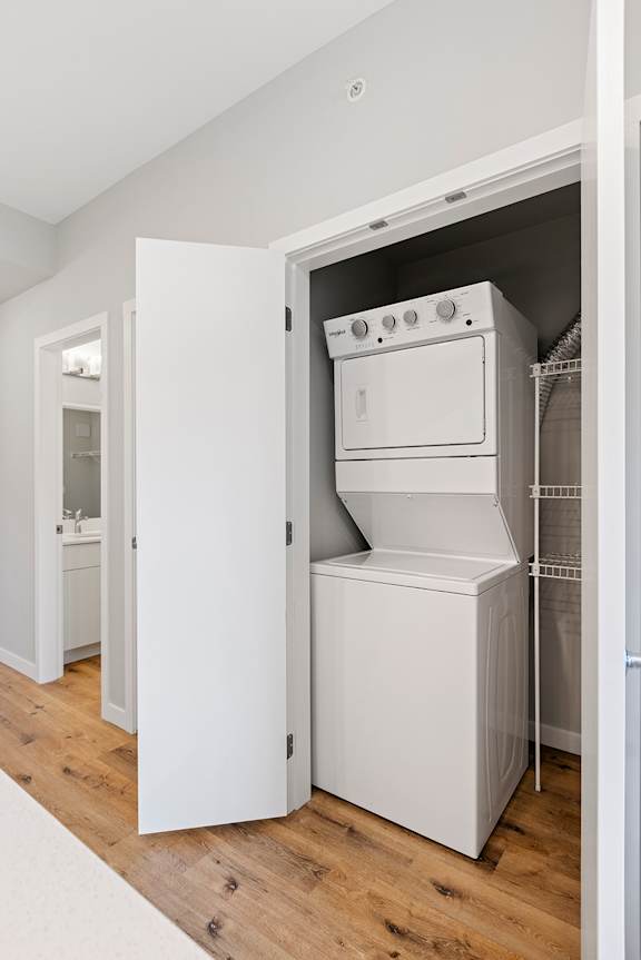 A white oven and fridge are installed in a kitchen.