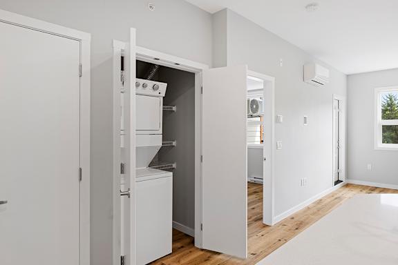 A white laundry room with a washer and dryer.