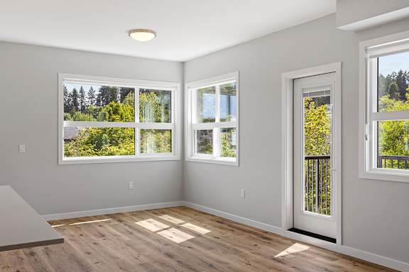 A room with a large window and a door.
