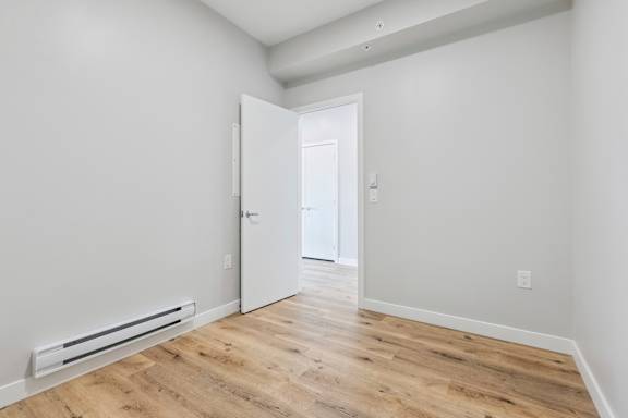 A room with a white door and a white wall.