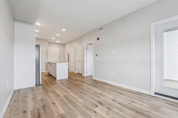 A room with wooden floors and white walls.