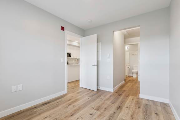 A room with a wooden floor and white walls.