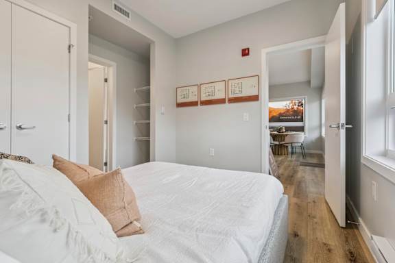 A bedroom with a bed and a window.
