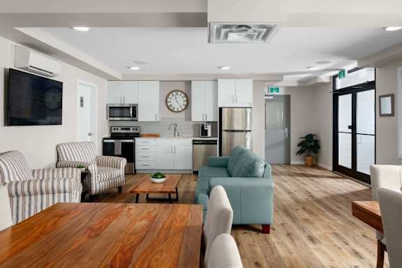 A modern kitchen with a wooden table and chairs.