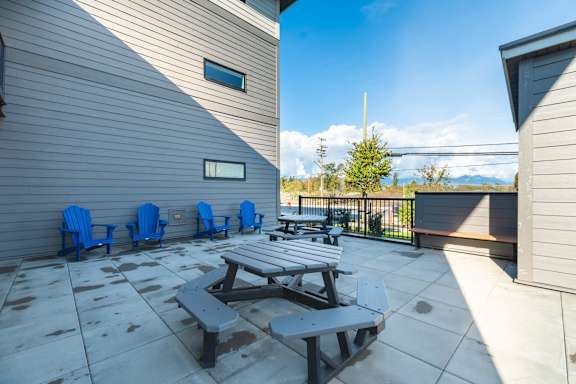 A patio with a table and chairs.