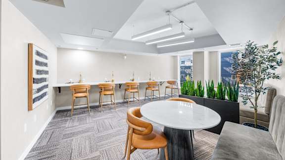 A conference room with a white table and chairs.