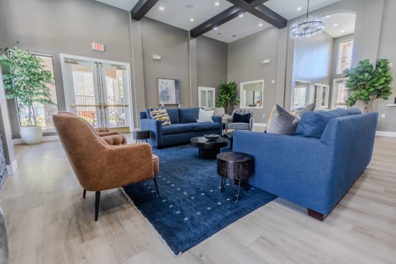 a living room with couches and chairs and a rug at Austin Crest Apartments, Reno, Nevada